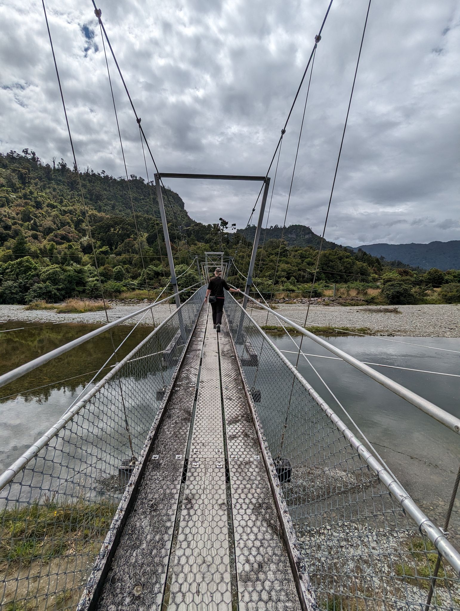  Aotearoa New Zealand, 13 Jan 2024  Crossing the Punakaiki River swing bridge.